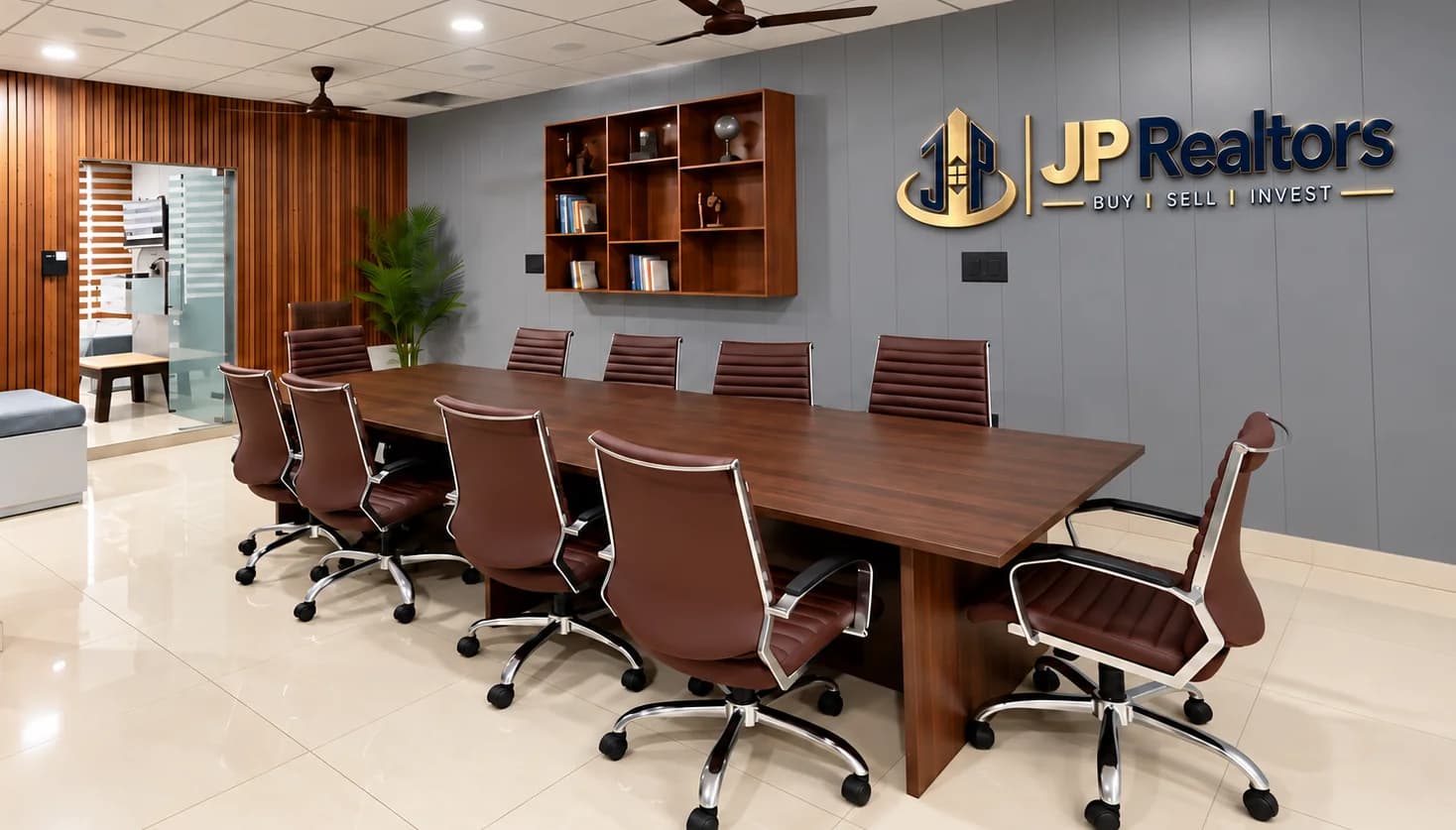 JP Realtors meeting room with a long boardroom table and the JP Realtors sign on the wall